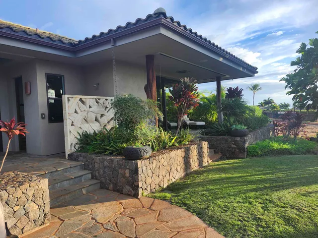 a bedroom with a bed and a large window with outer view