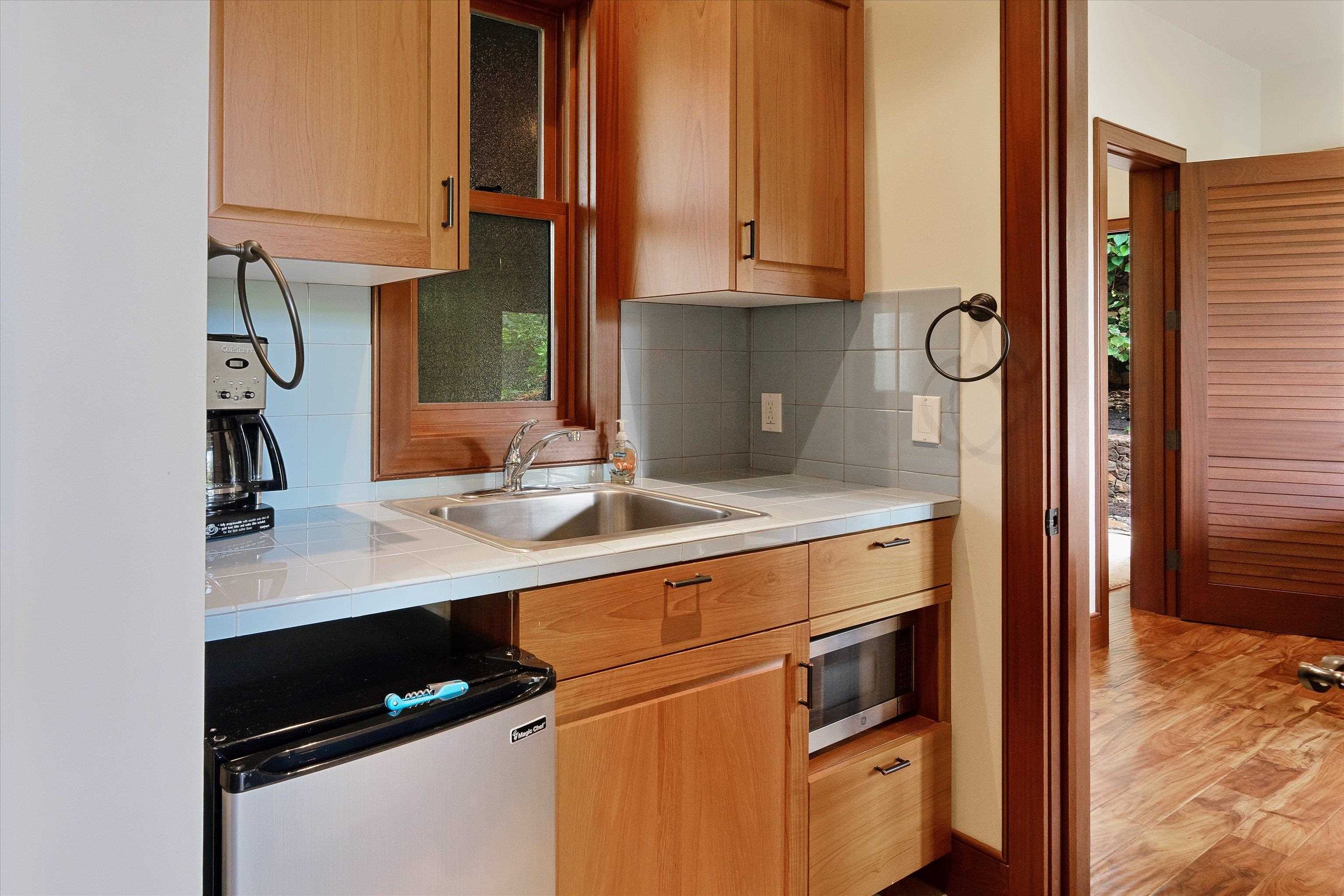 137 Anapuni Loop Lahaina, HI 96761 - Photo 37 of 47 a kitchen with stainless steel appliances granite countertop a sink and a refrigerator