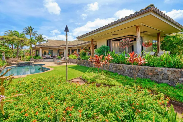 a view of a house with a big yard and potted plants