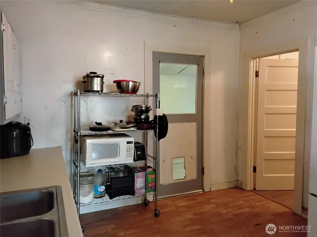 a kitchen with a refrigerator and a stove top oven