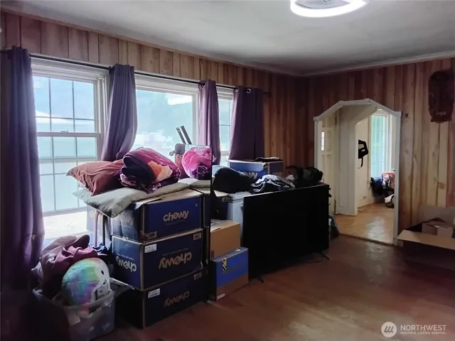 a bedroom with bed and glass door