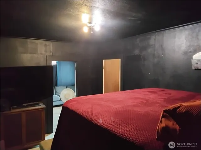 a view of bedroom with furniture and baby crib