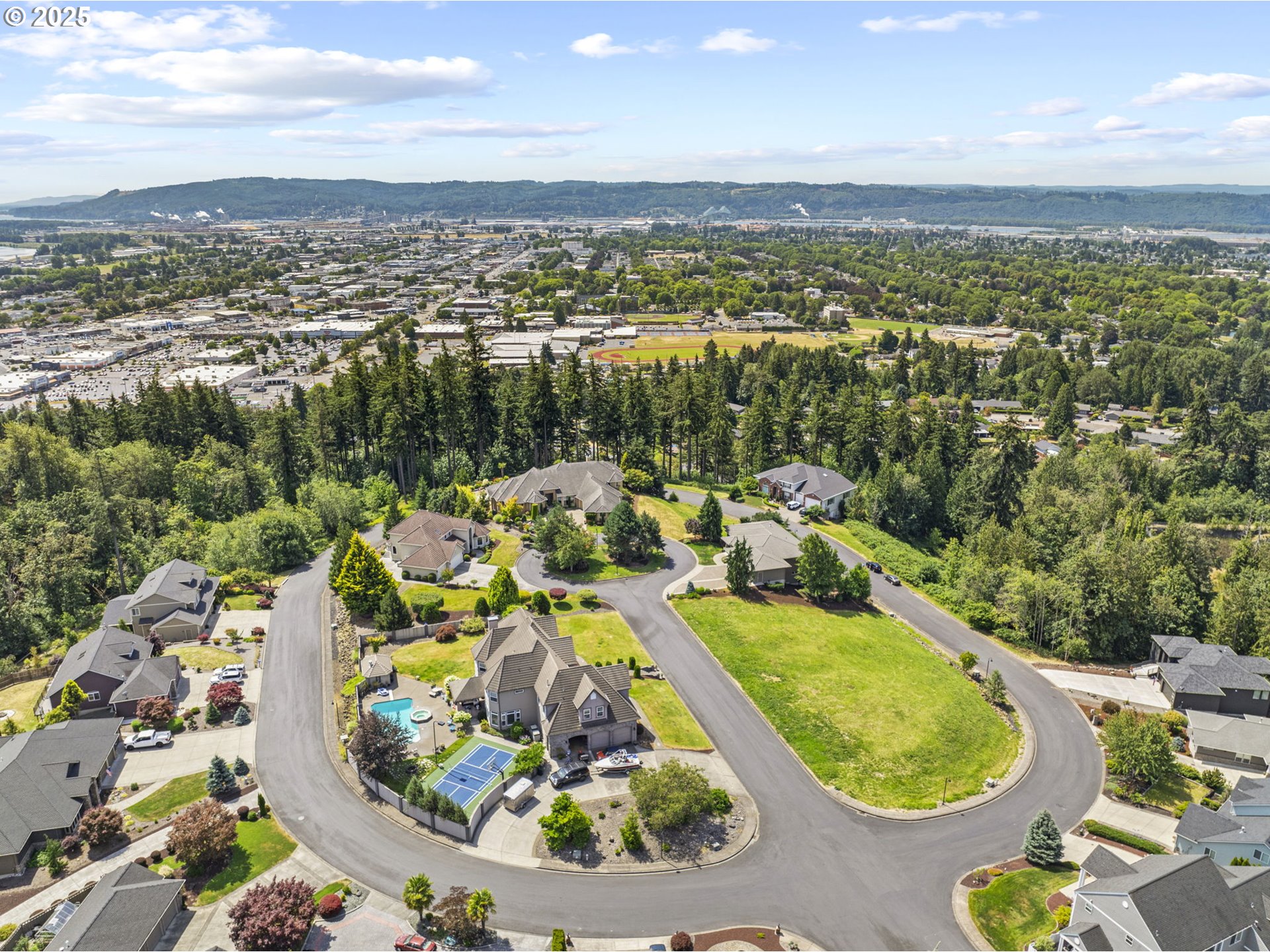 1 Center Court Longview, WA 98632 - Photo 20 of 21 an aerial view of a house with a swimming pool and mountains