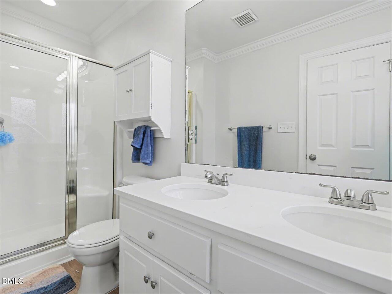 4828 Forest Highland Drive Raleigh, NC 27604 - Photo 13 of 27 a bathroom with a sink toilet vanity and shower