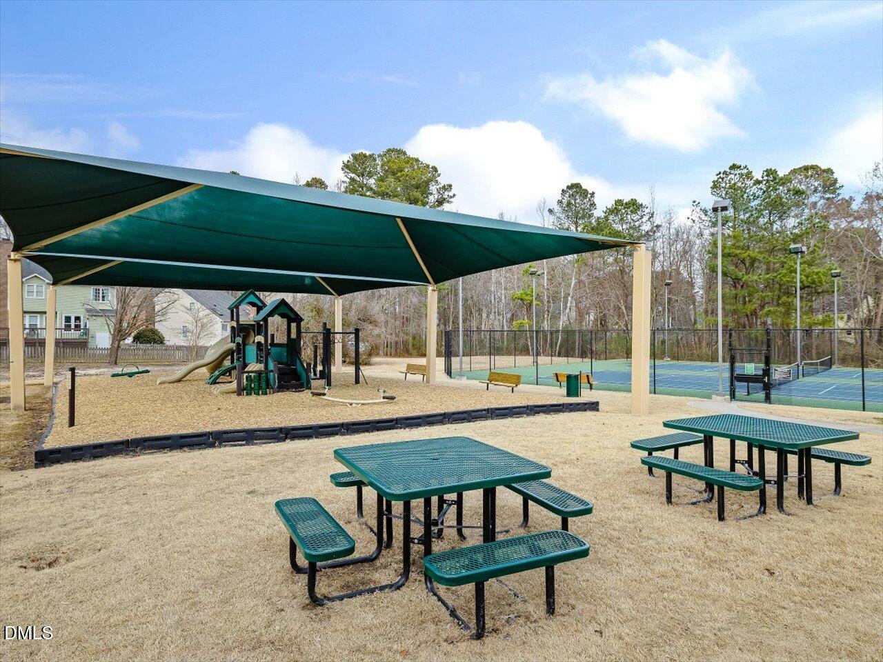 4828 Forest Highland Drive Raleigh, NC 27604 - Photo 23 of 27 a patio with a patio table and chairs