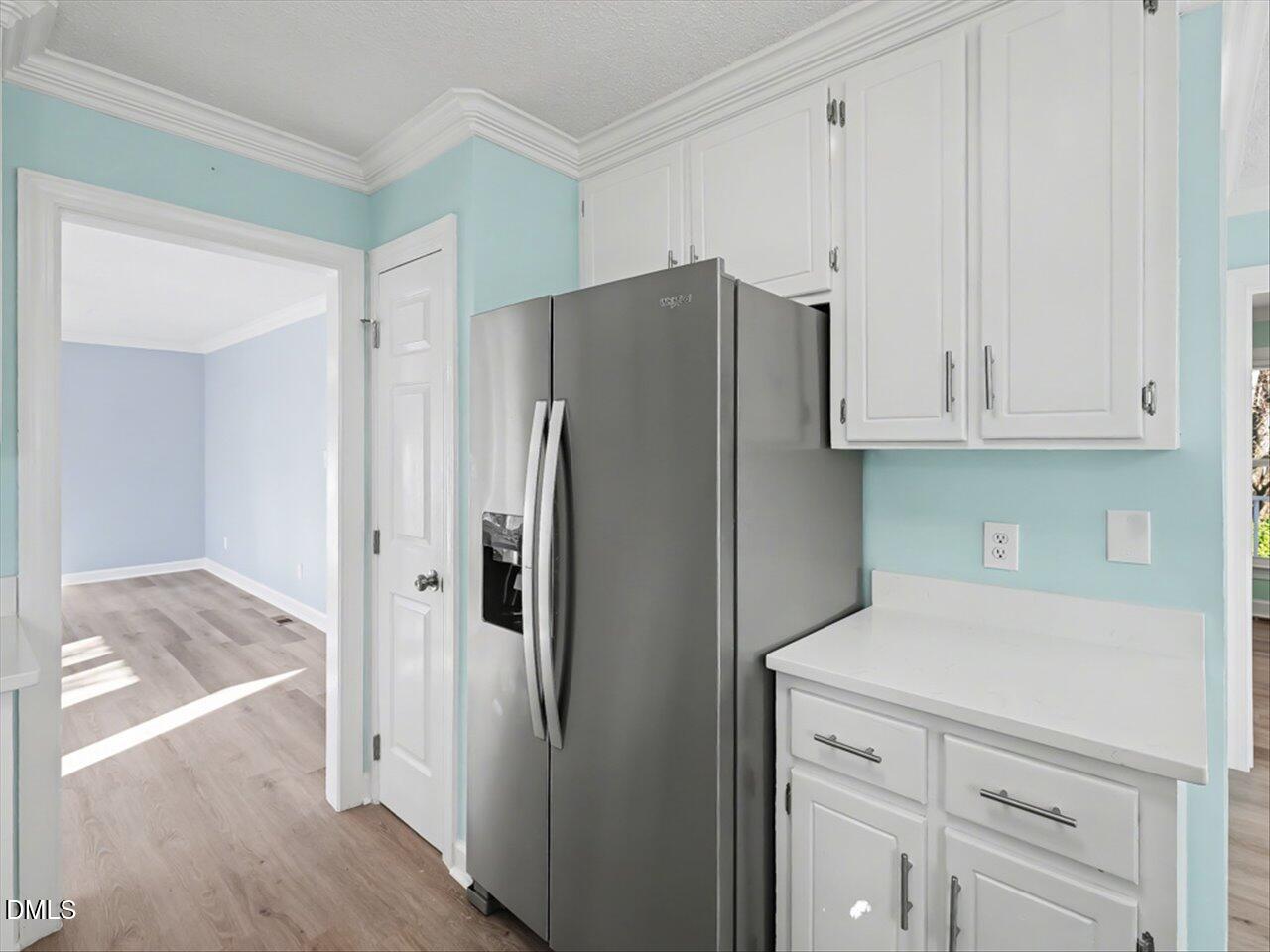 4828 Forest Highland Drive Raleigh, NC 27604 - Photo 3 of 27 a kitchen with stainless steel appliances white cabinets and a refrigerator