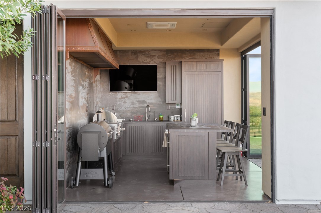 1123 Christian Road Henderson, NV 89002 - Photo 52 of 94 An inviting outdoor kitchen, perfect for alfresco dining and entertaining, features a built-in grill and ample counter space.
