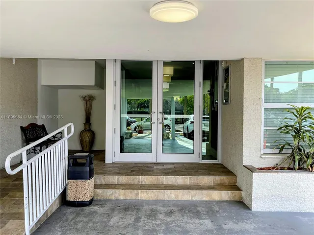 a view of a hallway with furniture and a refrigerator