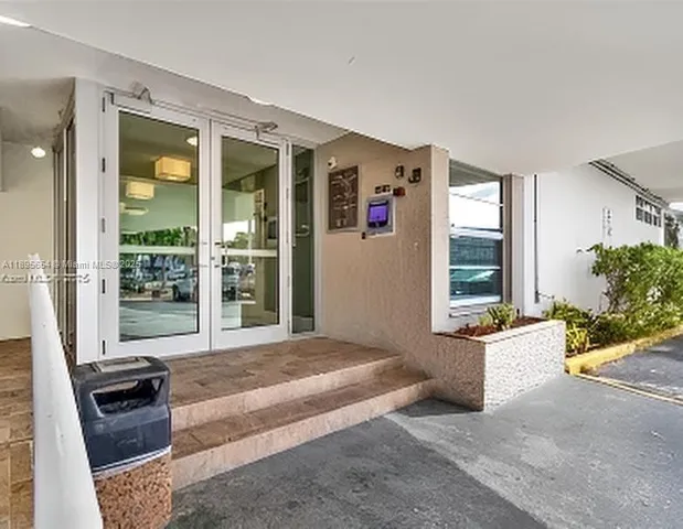 a spacious bedroom with a bed and glass door