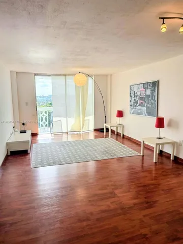 a living room with furniture window and wooden floor