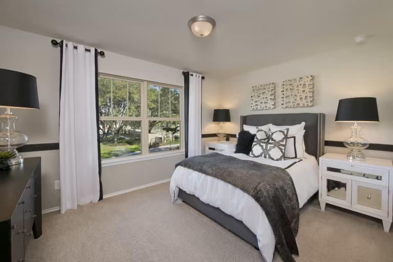 1804 Spg Mountain Cove Georgetown, TX 78628 - Photo 26 of 32 a large bed sitting in a bedroom next to a window