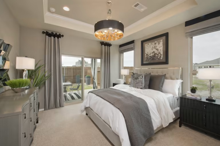 1804 Spg Mountain Cove Georgetown, TX 78628 - Photo 29 of 32 a spacious bedroom with a bed and a chandelier