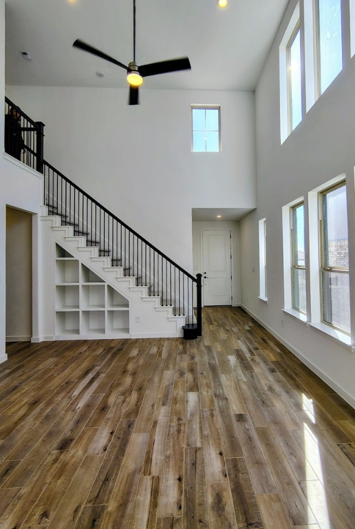 1804 Spg Mountain Cove Georgetown, TX 78628 - Photo 2 of 32 a view of a hallway with wooden floor and a ceiling fan
