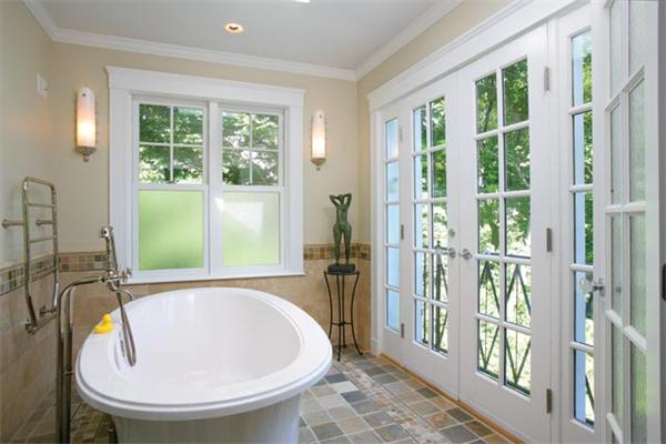 91 Nehoiden Road Newton, MA 02468 - Photo 8 of 12 a view of a bathroom with a tub and glass door