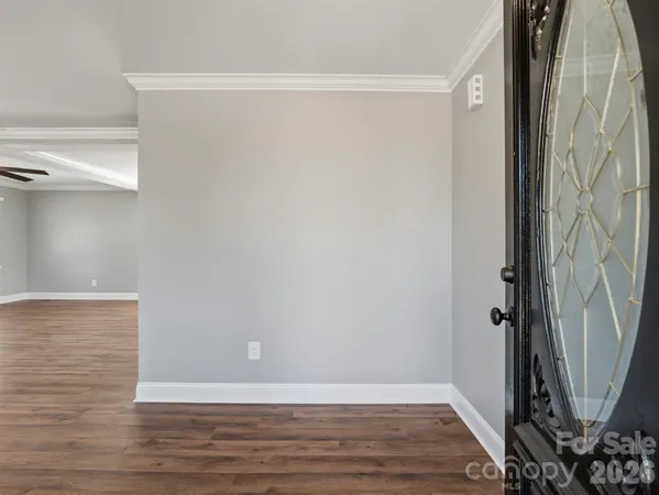 a view of a room with wooden floor and a shower