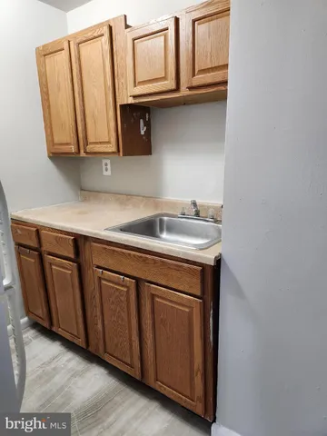 a view of a livingroom with wooden floor and a fireplace
