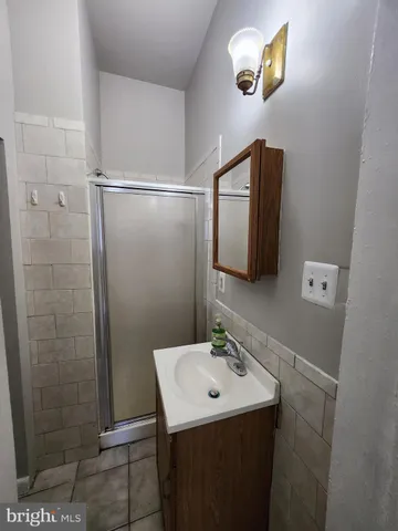 a view of empty room with window and wooden floor