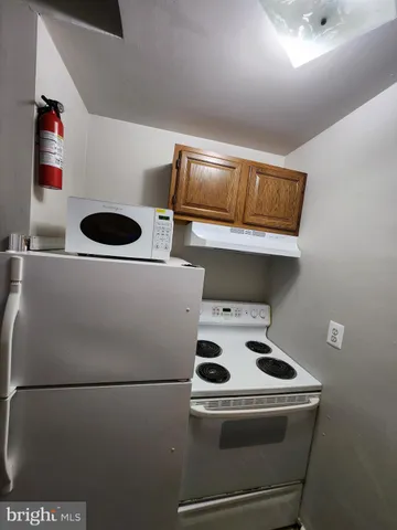 a view of a room with wooden floor and white walls