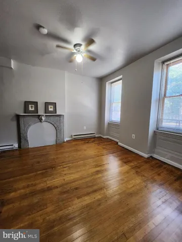 a view of hallway with wooden floor