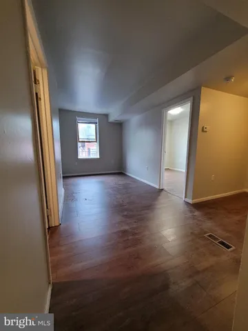 a living room with hard wood floors and a wooden floor