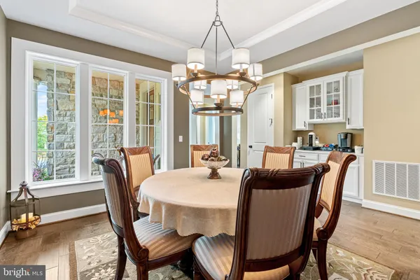a kitchen with stainless steel appliances a dining table and chairs