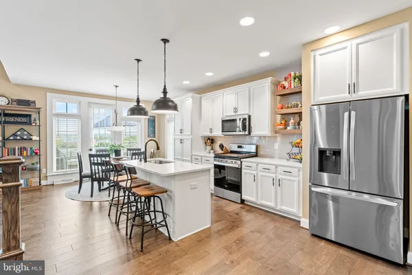 a kitchen that has a table and chairs