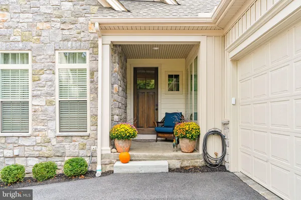 a front view of a house with outdoor seating