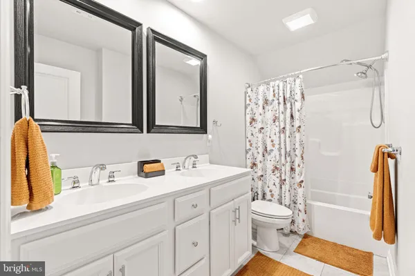 a bathroom with a sink vanity mirror and toilet