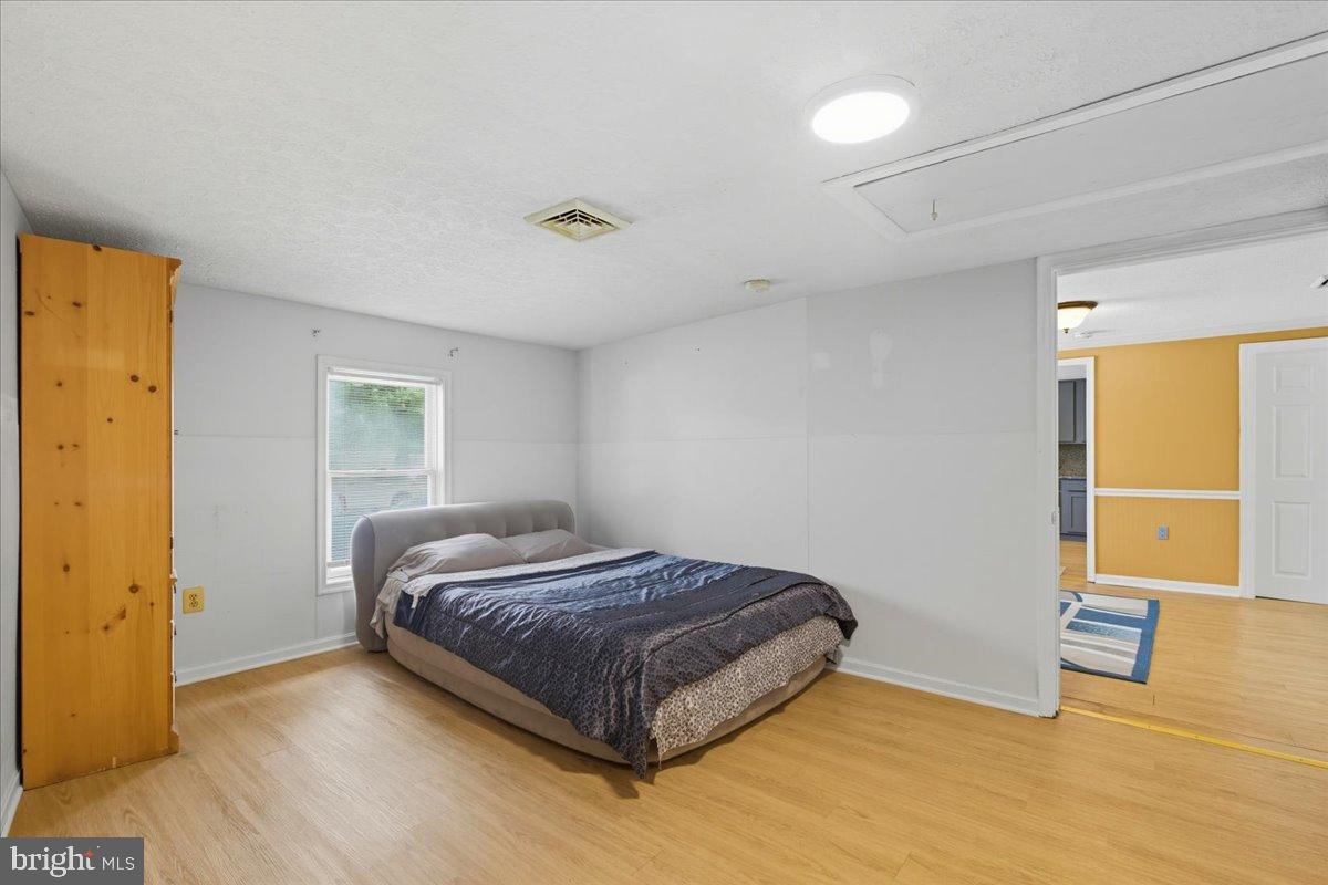 619 Aspen Lane Edgewood, MD 21040 - Photo 14 of 35 a bedroom with a bed and a table in it