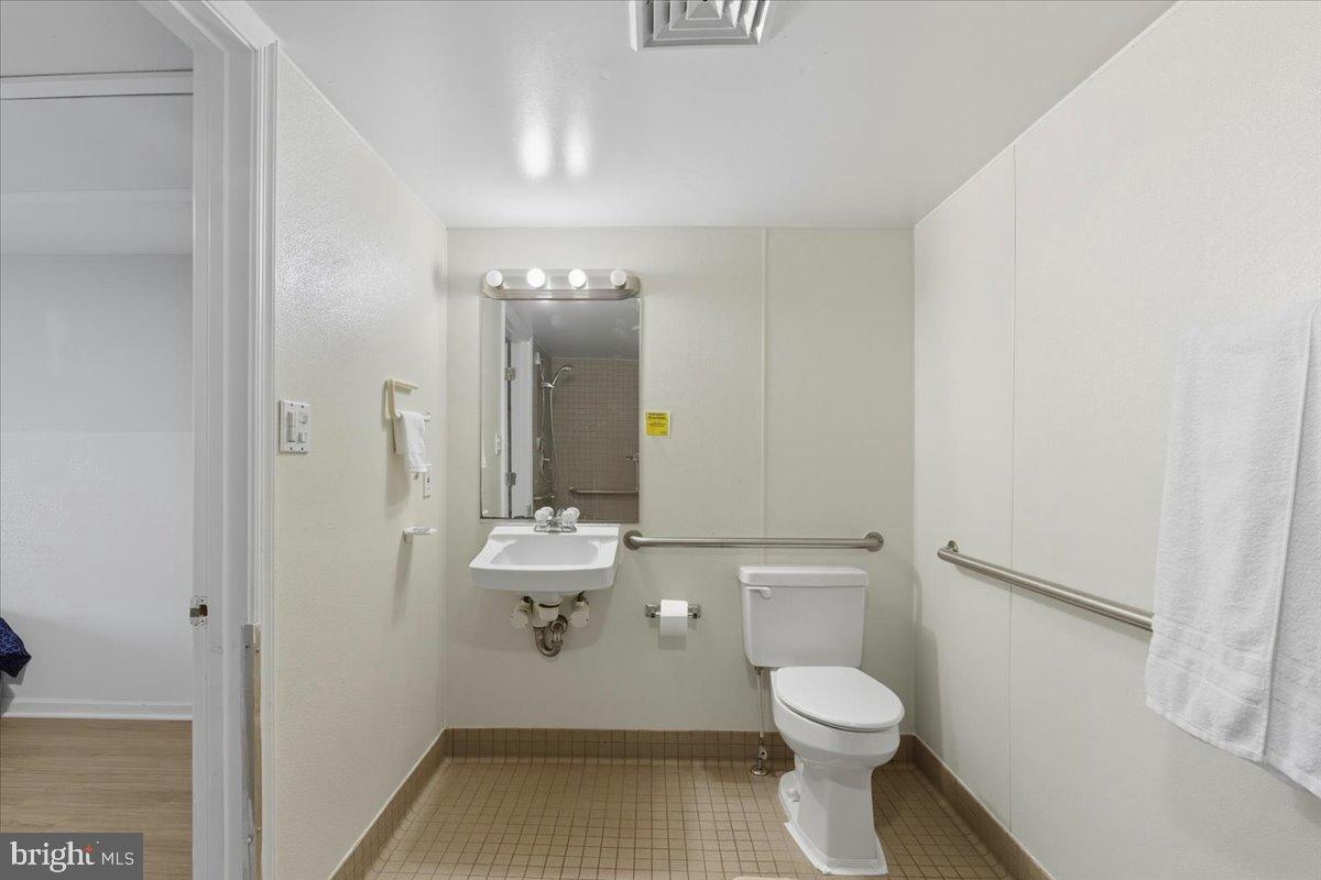 619 Aspen Lane Edgewood, MD 21040 - Photo 17 of 35 a bathroom with a toilet a sink and mirror