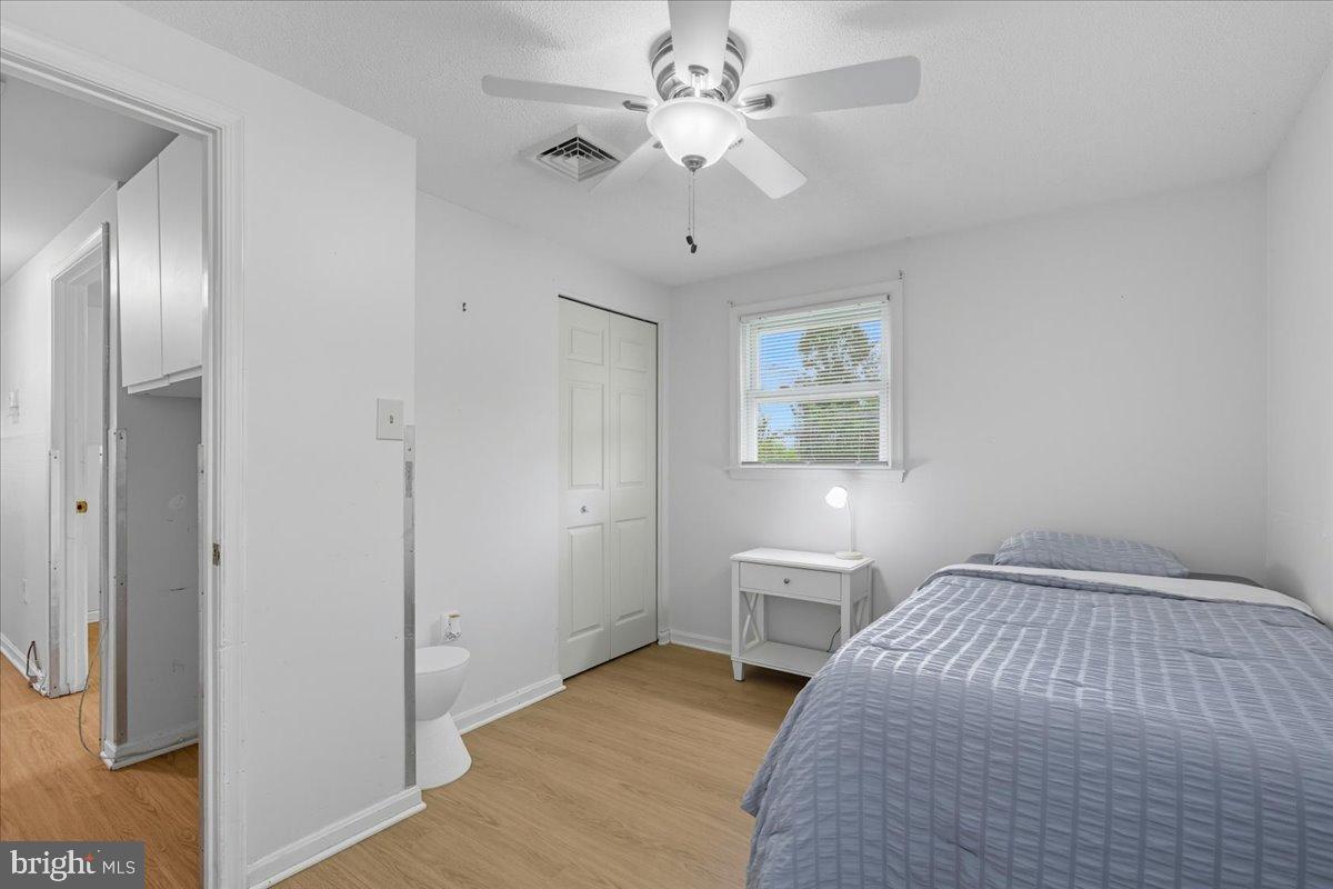 619 Aspen Lane Edgewood, MD 21040 - Photo 21 of 35 a bedroom with a bed and a chandelier