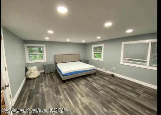 a bedroom with a bed and a night stand