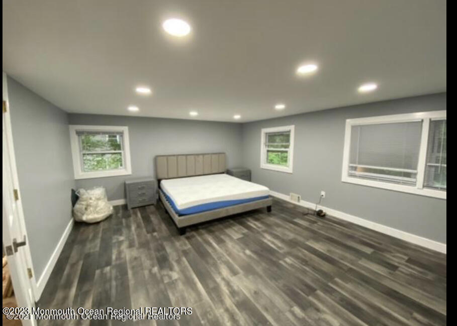 437 Redmond Avenue Oakhurst, NJ 07755 - Photo 13 of 26 a spacious bedroom with a bed and wooden floor