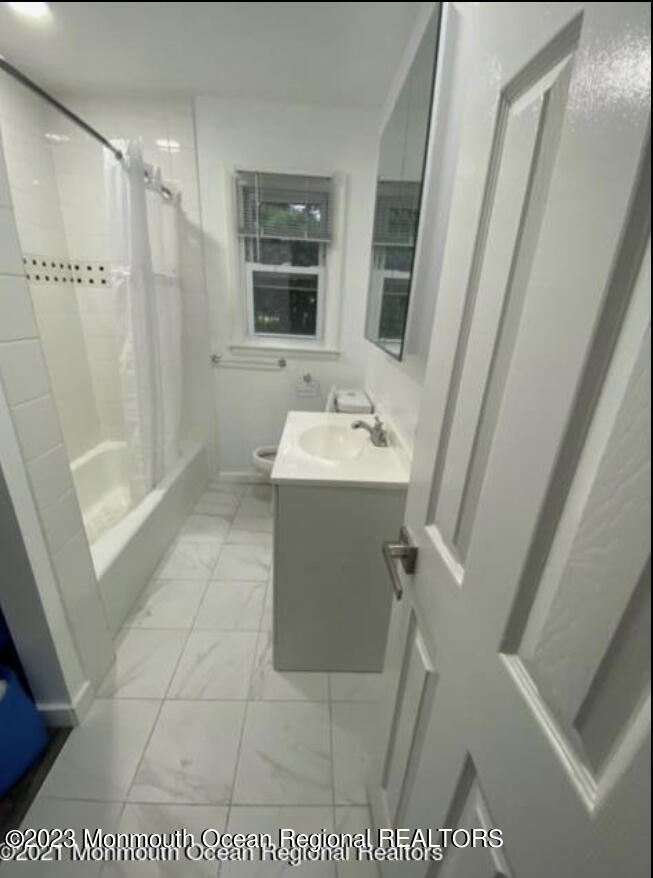 437 Redmond Avenue Oakhurst, NJ 07755 - Photo 14 of 26 a bathroom with a sink a toilet a mirror and shower