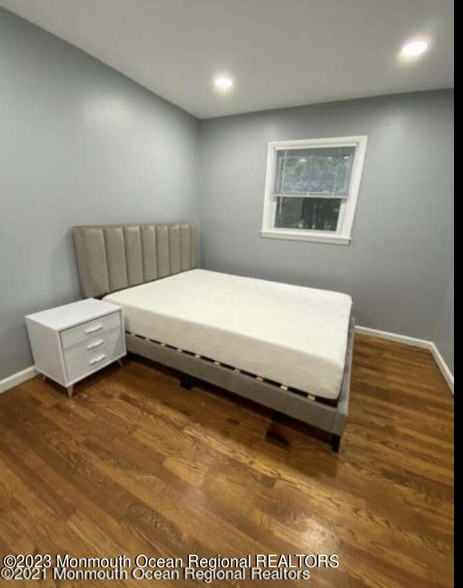 437 Redmond Avenue Oakhurst, NJ 07755 - Photo 15 of 26 a bedroom with a bed and a night stand