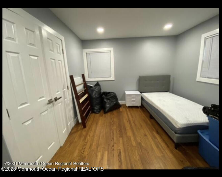 437 Redmond Avenue Oakhurst, NJ 07755 - Photo 16 of 26 a bedroom with a bed and wooden floor
