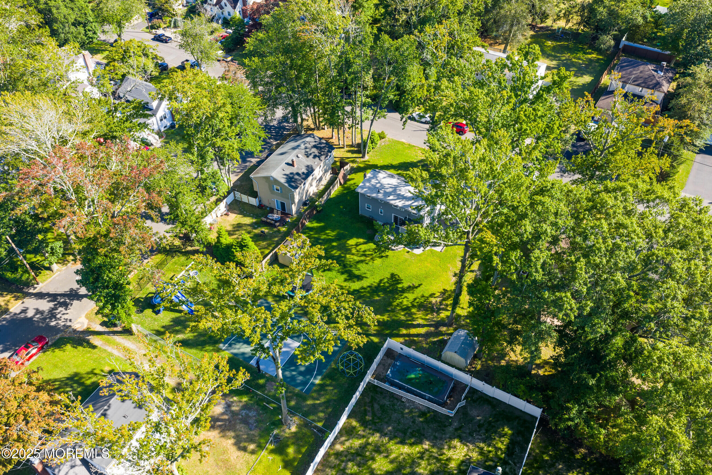 437 Redmond Avenue Oakhurst, NJ 07755 - Photo 18 of 26 a backyard of a house with lots of green space and a fountain