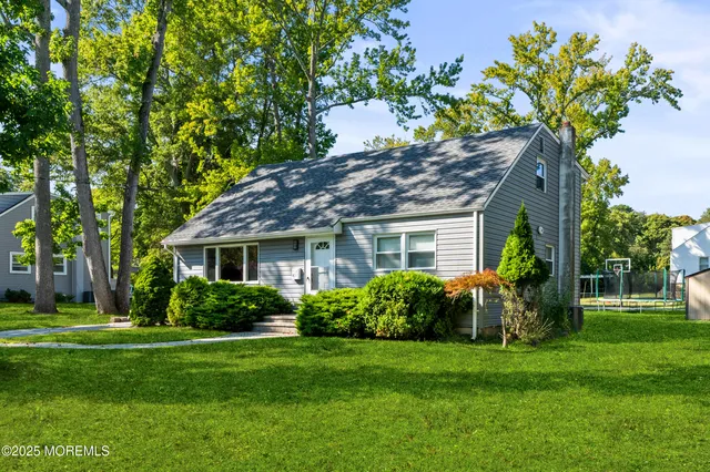 a front view of house with a garden