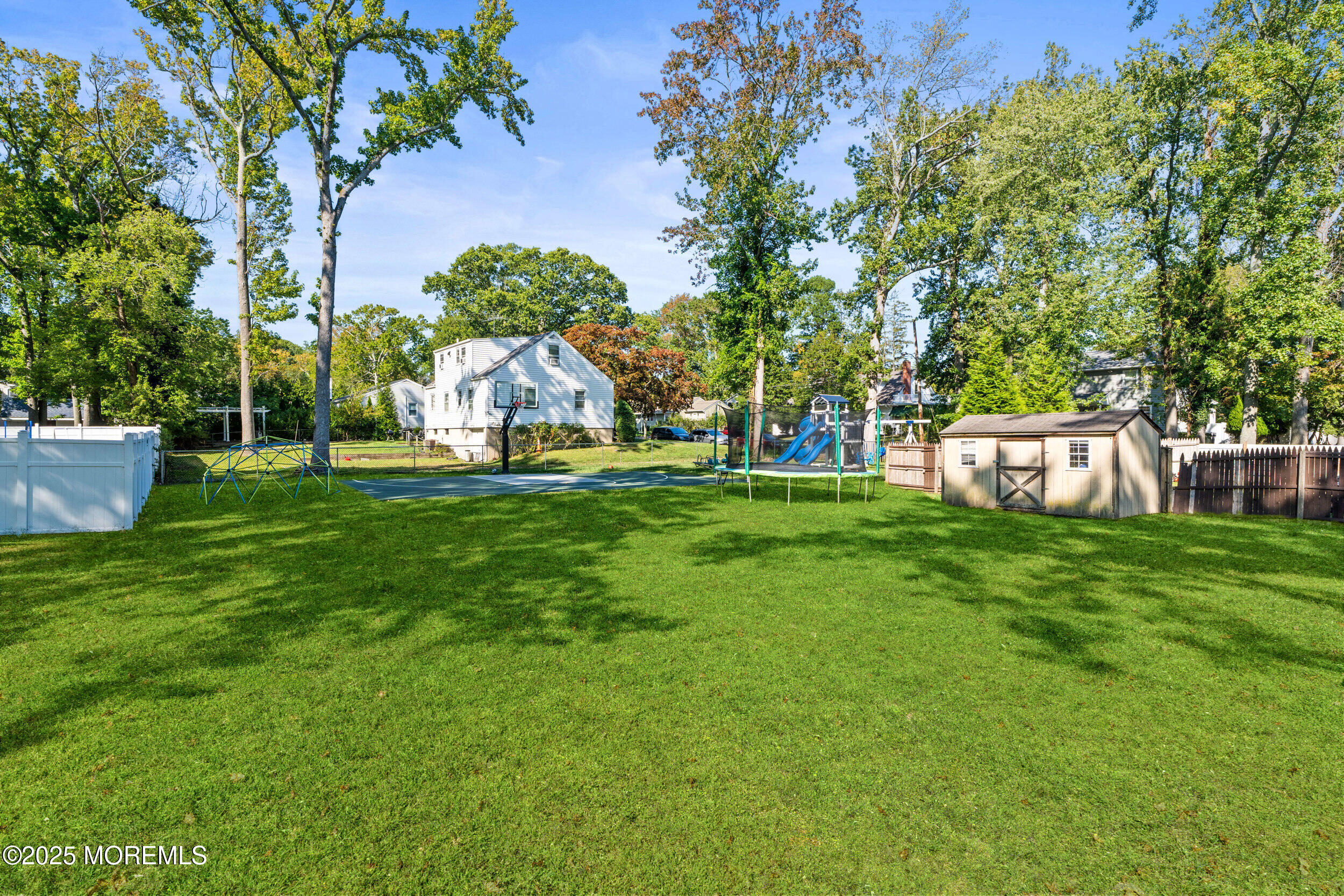 437 Redmond Avenue Oakhurst, NJ 07755 - Photo 3 of 26 a view of a backyard with a garden