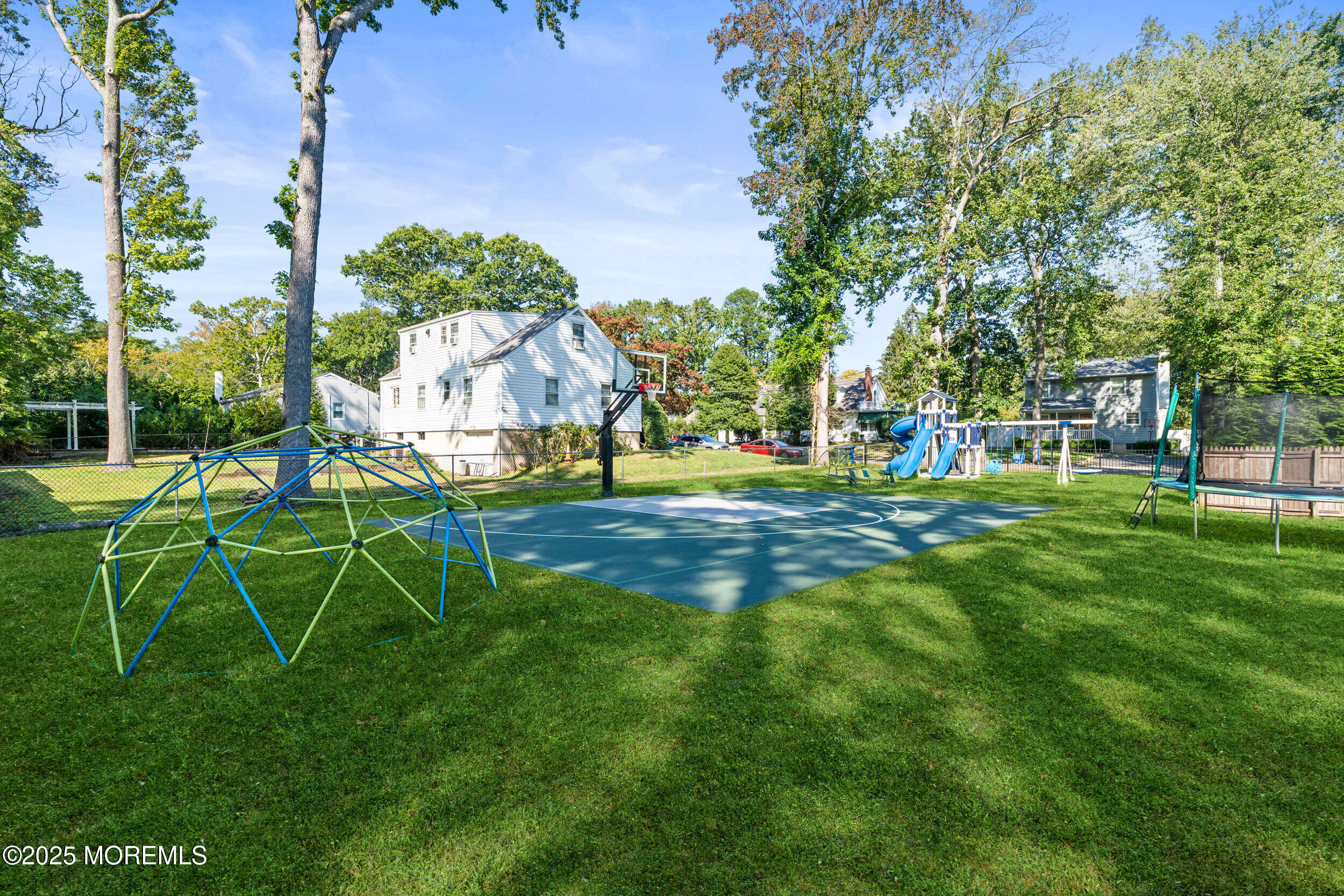 437 Redmond Avenue Oakhurst, NJ 07755 - Photo 4 of 26 a view of a park with swings and slides