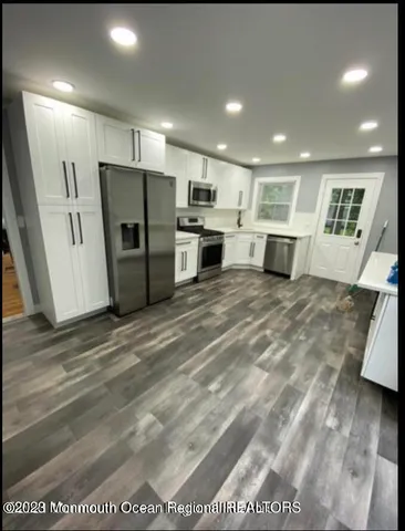 a kitchen with kitchen island a stove a sink and a refrigerator