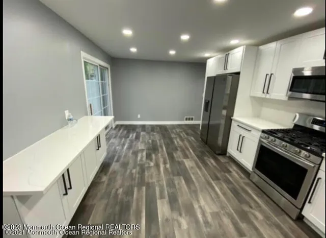 a view of a kitchen with a sink and a window
