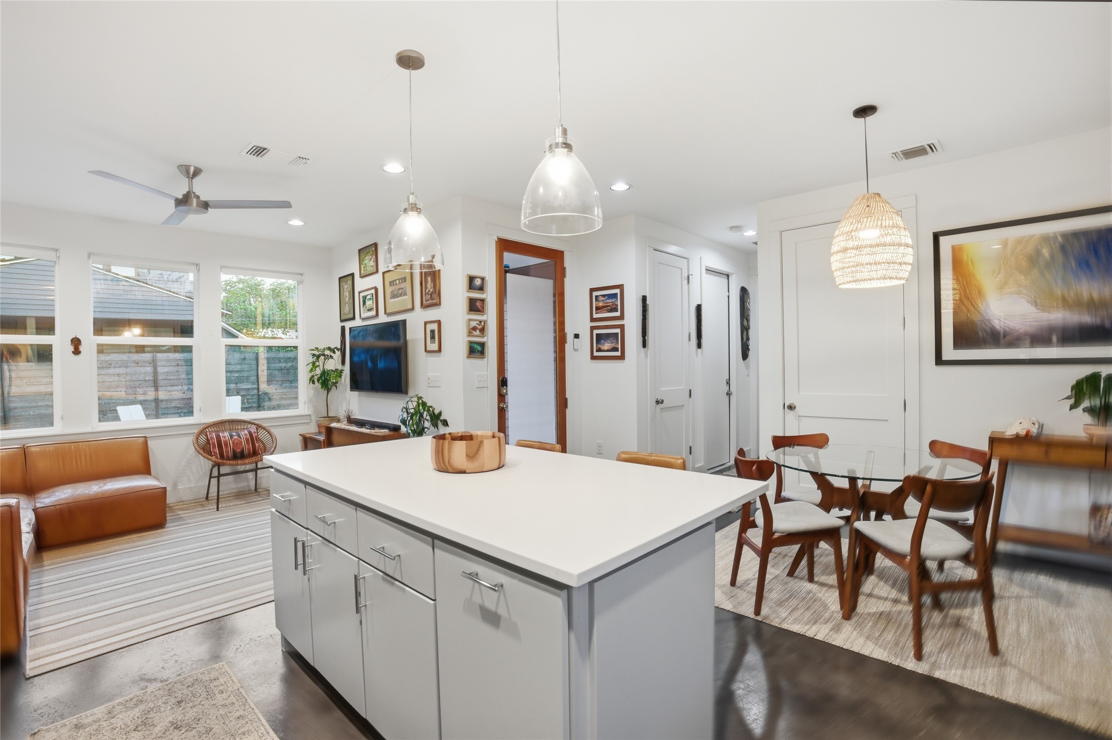 1709 Perez Street, Unit 2 Austin, TX 78721 - Photo 17 of 33 An open-concept living space integrates a well-appointed kitchen island with distinct dining and lounge areas.