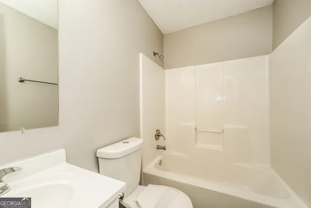 a bathroom with a toilet and a bathtub