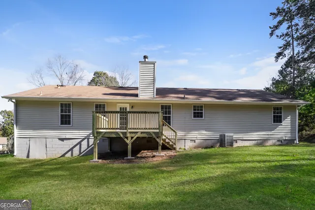 a view of a house with backyard sitting area and garden