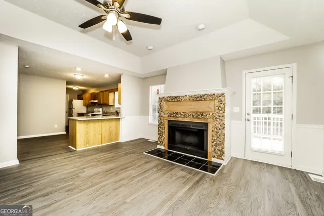 a view of kitchen and fireplace with wooden floor