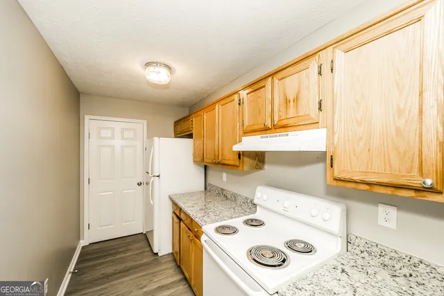 a kitchen with a stove a sink and a refrigerator