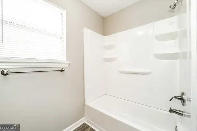 a bathroom with a bathtub and a shower