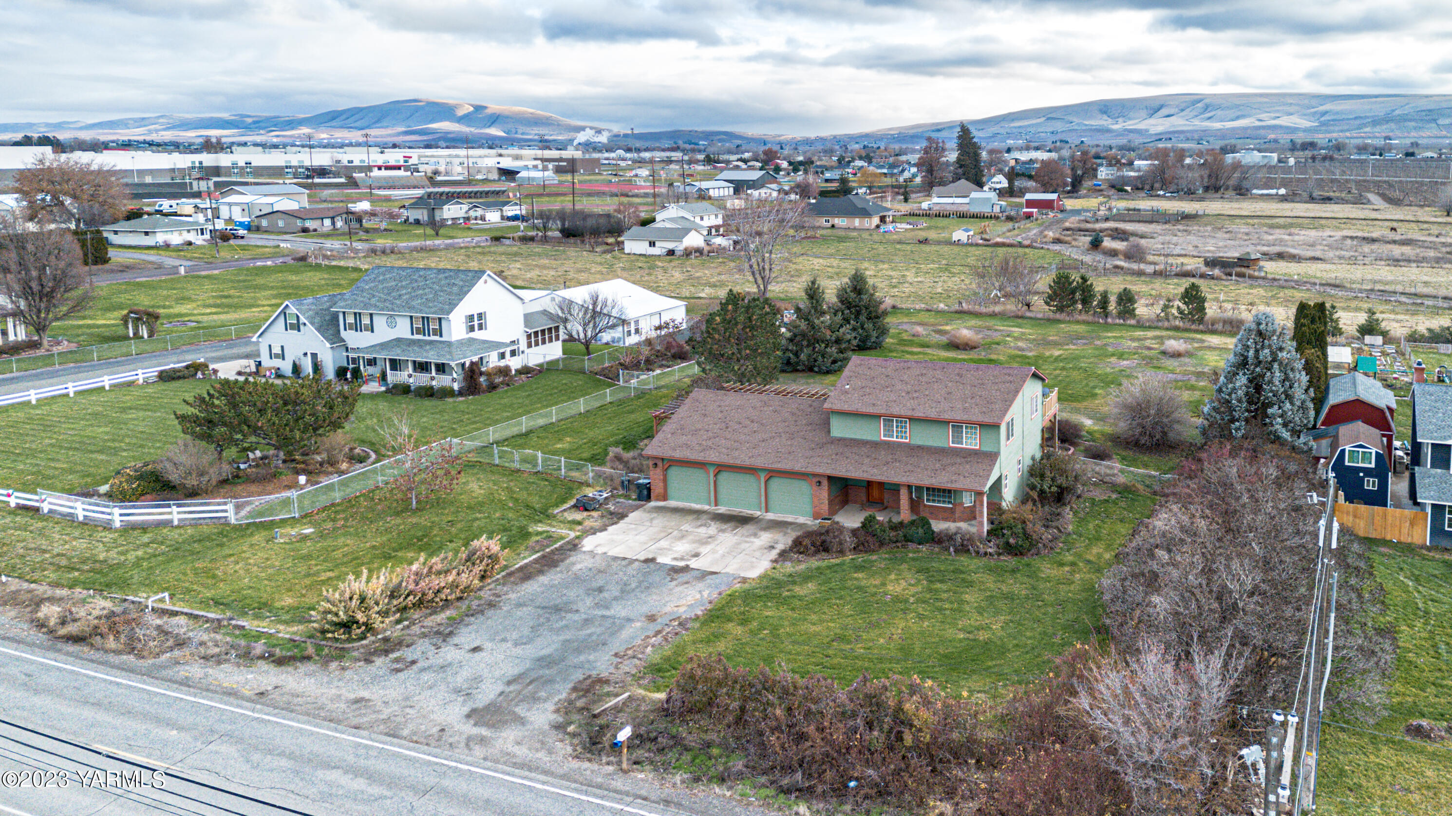 6706 Mieras Road Yakima, WA 98901 - Photo 1 of 43 an aerial view of a house with a garden and lake view
