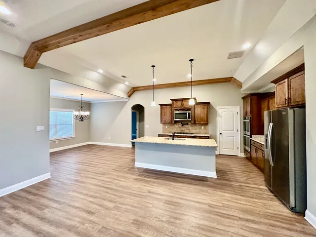 a view of kitchen with sink microwave and refrigerator